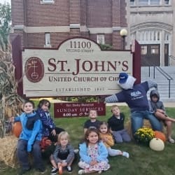 Kids posing in front of St. John's United Church of Christ sign